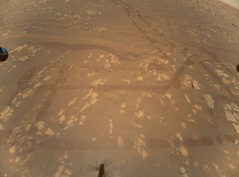 Foto area de Marte, feita em 22 de abril de 2021 pelo drone Ingenuity, mostra a superfcie do planeta e as marcas deixadas pelo rover Perseverance. 